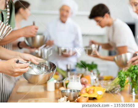 Group of people learning how to cook at master class 135303503