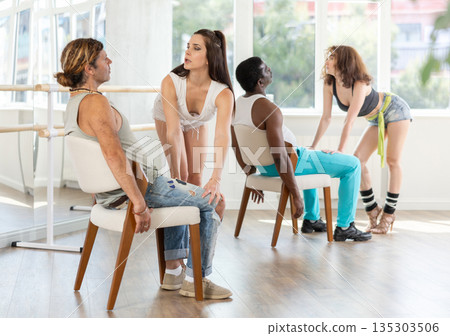 Female dancer mastering lap dance with man sitting on chair in studio Female dancer mastering lap dance with man sitting on chair in studio 135303506