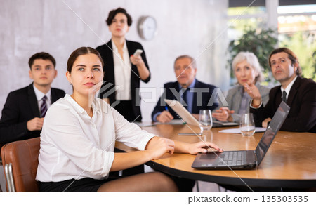 Group of business people attending meeting in conference room, discussing work plan 135303535