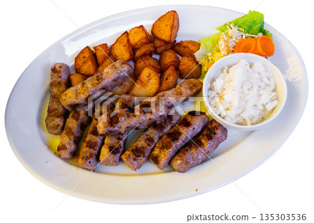 Grilled kebab turkish style barbecued minced meat with sauce. Traditional Balkan food - cevapi or cevapcici 135303536