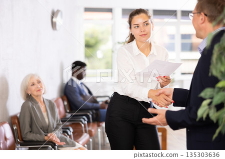 Adult man and young woman make an agreement 135303636