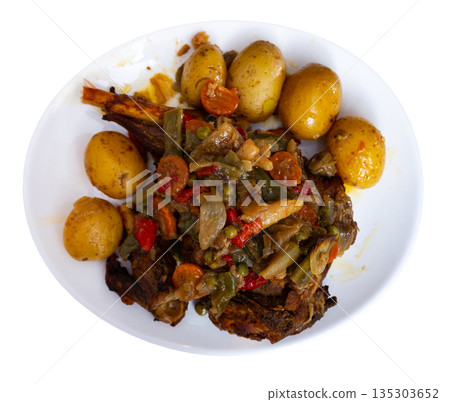 Chicken leg baked with vegetables served with side dish of boiled potatoes. Chicken leg baked with vegetables served with side dish of boiled potatoes. 135303652