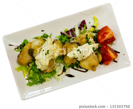 Cod with tartar sauce and herbs on served table 135303798