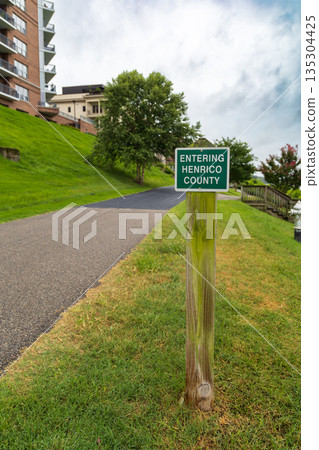 A green sign on a wooden post that says "Entering Henrico County." A green sign on a wooden post that says "Entering Henrico County." 135304425