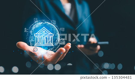 Digital banking concept with businessman holding smartphone and glowing bank icon over global network sphere, illustrating online finance, mobile payments, secure transactions and fintech services. Digital banking concept with businessman holding smartphone and glowing bank icon over global network sphere, illustrating online finance, mobile payments, secure transactions and fintech services. 135304481