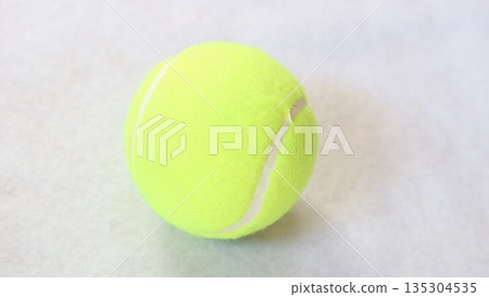 A hard tennis ball placed on a white background 135304535