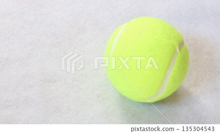 A hard tennis ball placed on a white background 135304543