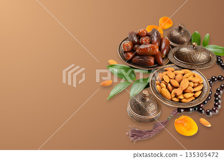 Table decor includes dates, nuts, and prayer beads 135305472