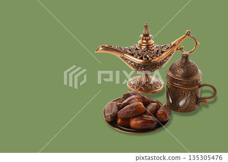 Decorative setup showcasing Arabic coffee pot with dates on plate Decorative setup showcasing Arabic coffee pot with dates on plate 135305476