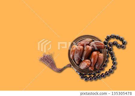 Dates and prayer beads placed on a vibrant background for Ramadan Dates and prayer beads placed on a vibrant background for Ramadan 135305478