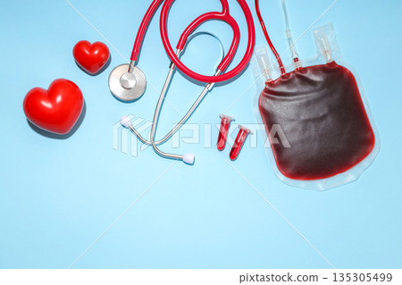 Stethoscope, blood bag, hearts, test tubes on blue Stethoscope, blood bag, hearts, test tubes on blue 135305499