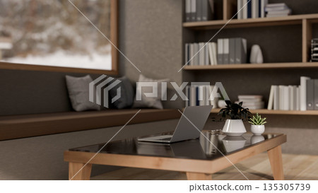 Laptop on glass top wooden table and a long bench with pillow cushions in a living room or library. Laptop on glass top wooden table and a long bench with pillow cushions in a living room or library. 135305739