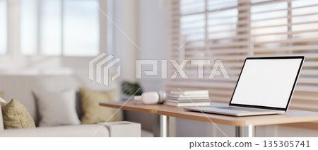 White screen laptop with book on wooden stool table and sofa aside blinds covered glass wall in cafe White screen laptop with book on wooden stool table and sofa aside blinds covered glass wall in cafe 135305741