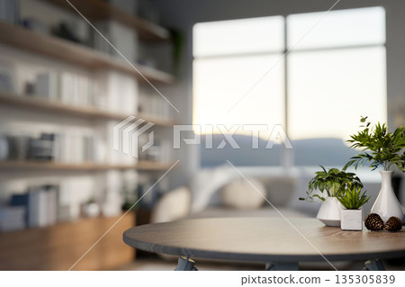 Decorative acorns with flower vase and pot plants on wooden table in a bright living room or library. 135305839