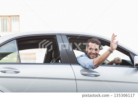 Male leaning out driver window of silver sedan waving hand wearing wristwatch on street, copy space Male leaning out driver window of silver sedan waving hand wearing wristwatch on street, copy space 135306117