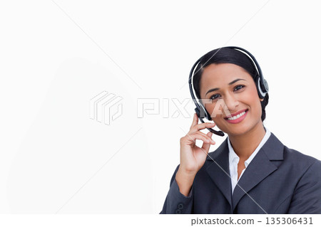 Asian woman standing in studio against white backdrop, wearing gray blazer and headset, copy space Asian woman standing in studio against white backdrop, wearing gray blazer and headset, copy space 135306431
