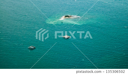 beautiful view of the island with fish cages in the sea beautiful view of the island with fish cages in the sea 135306502