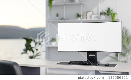 Blank screen computer on wooden table in a bright white room with green potted plants and decor item Blank screen computer on wooden table in a bright white room with green potted plants and decor item 135306531