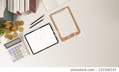 Blank screen tablet with calculator and clipboard aside book and gold coins on office working table. Blank screen tablet with calculator and clipboard aside book and gold coins on office working table. 135306545