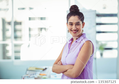 South Asian woman smiling, crossing arms at office desk with papers and sticky notes, copy space South Asian woman smiling, crossing arms at office desk with papers and sticky notes, copy space 135307125