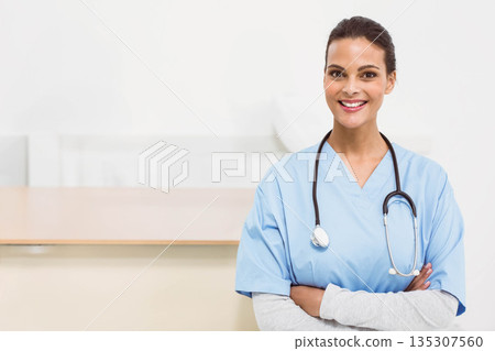 Adult female nurse standing at reception counter in scrubs with stethoscope, copy space Adult female nurse standing at reception counter in scrubs with stethoscope, copy space 135307560