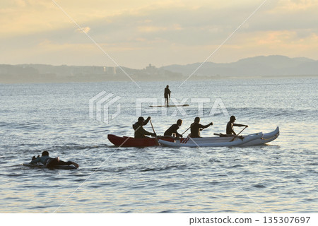 SUP and canoe paddlers in the morning glow on New Year's Day 135307697