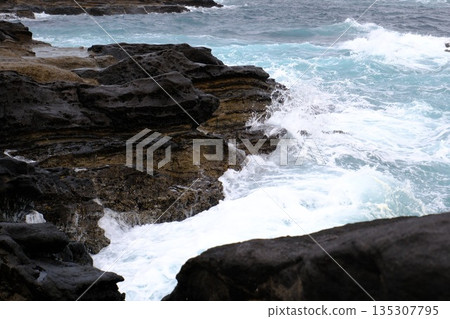 Rough waves crashing against rocks Rough waves crashing against rocks 135307795