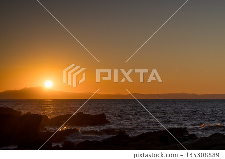 The reef and seascape illuminated by the sunset The reef and seascape illuminated by the sunset 135308889