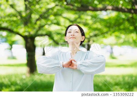 Young woman stretching under a tree Lifestyle image 135309222