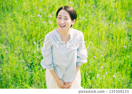 Young woman stretching in the grassland Lifestyle image Young woman stretching in the grassland Lifestyle image 135309233