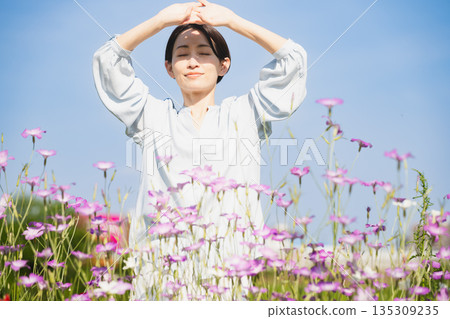 Young woman stretching outdoors Lifestyle image Young woman stretching outdoors Lifestyle image 135309235
