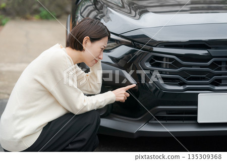 Female checking for car scratches Female checking for car scratches 135309368