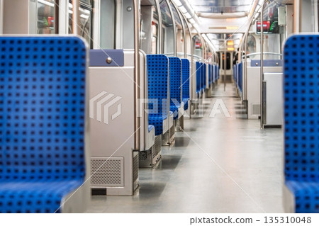 Empty Subway Car Interior with Blue Seats and Neutral Tones for Commuting and Travel Scenarios Empty Subway Car Interior with Blue Seats and Neutral Tones for Commuting and Travel Scenarios 135310048