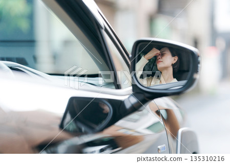 Woman feeling dizzy while driving 135310216