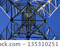 High-voltage power line tower with blue sky background 135310251