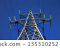 High-voltage power line tower with blue sky background 135310252