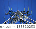 High-voltage power line tower with blue sky background 135310253