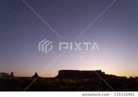 Starry sky over Monument Valley - just before the moon rises Starry sky over Monument Valley - just before the moon rises 135310401
