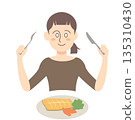 Woman eating fish dish 135310430