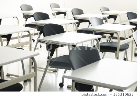 A school classroom with rows of desks and chairs 135310622