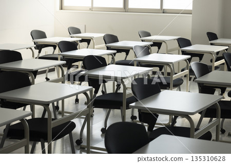 A school classroom with rows of desks and chairs 135310628