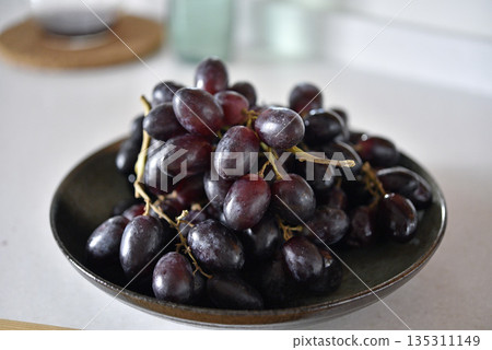 Black grape on black plate. Black grape on black plate. 135311149