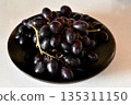 Black grape on black plate. 135311150