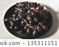 Black grape on black plate. 135311151