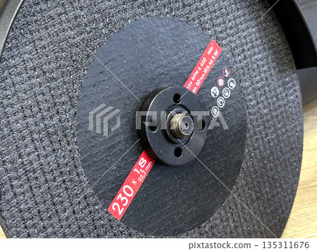 Close-up of a circular abrasive grinding wheel. Close-up of a circular abrasive grinding wheel. 135311676