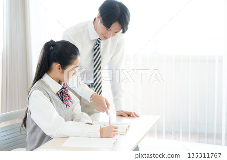 High school students studying at a cram school and their instructor High school students studying at a cram school and their instructor 135311767