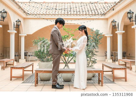新娘和新郎拿著花束互相凝視(婚禮、新娘、情侶) 新娘和新郎拿著花束互相凝視(婚禮、新娘、情侶) 135311908