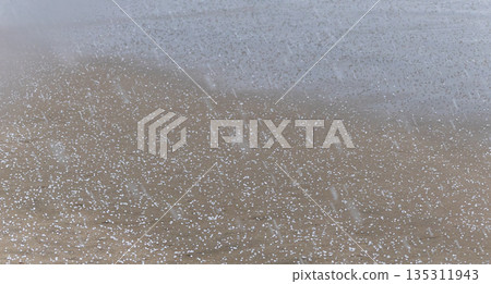 Sudden hailstorms falling on a sandy beach in the San'in region in winter 135311943