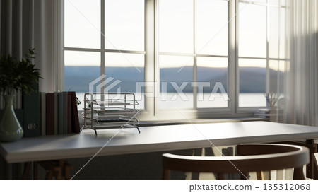 Paper drawer and file folders with vase on white table in a bright room with sunlight through window 135312068