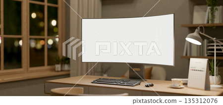 Blank curve screen computer aside coffee, calendar and lamp on wooden table in a room with bookshelf Blank curve screen computer aside coffee, calendar and lamp on wooden table in a room with bookshelf 135312076